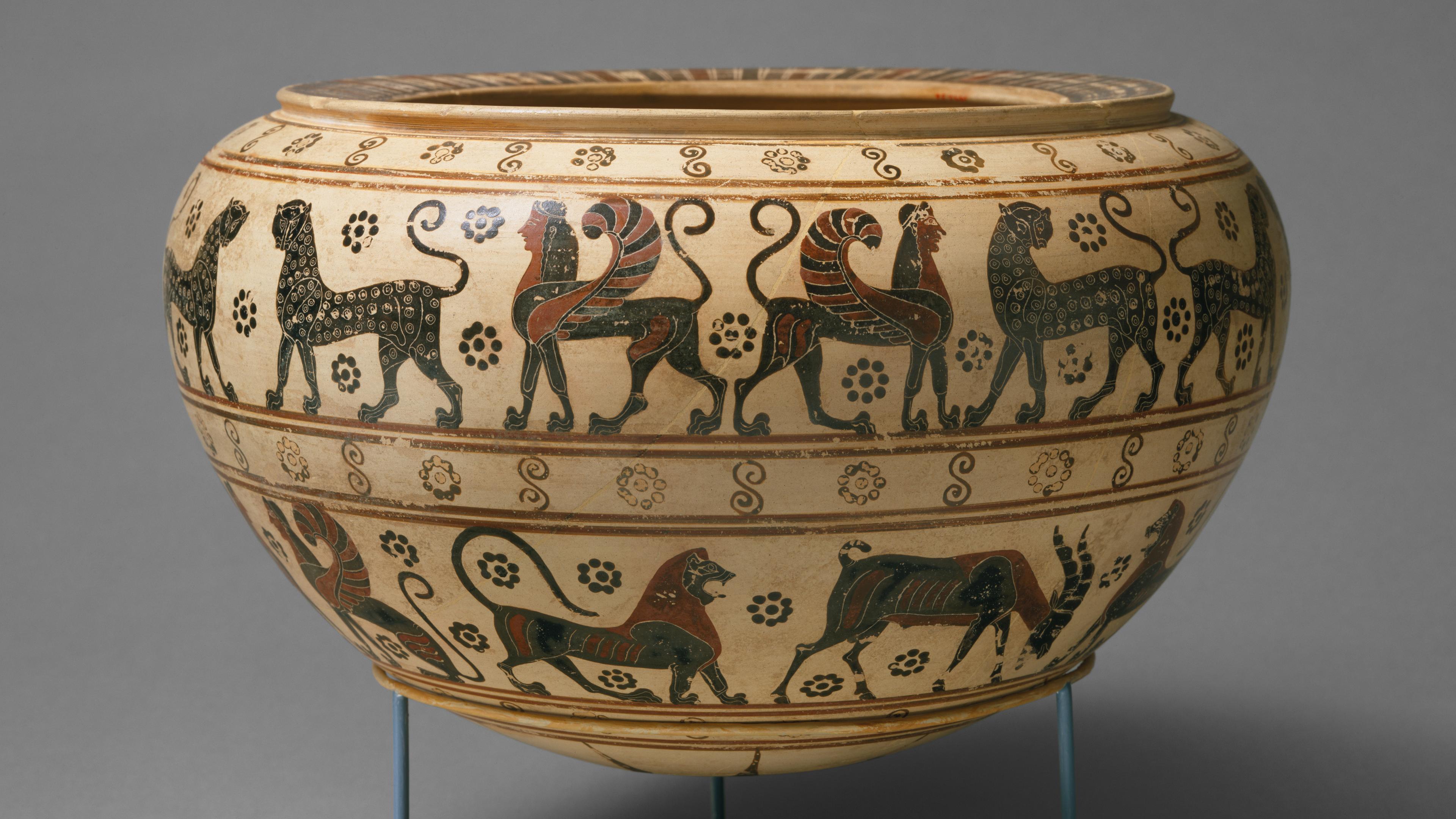 Wide terracotta bowl painted with animal motifs.