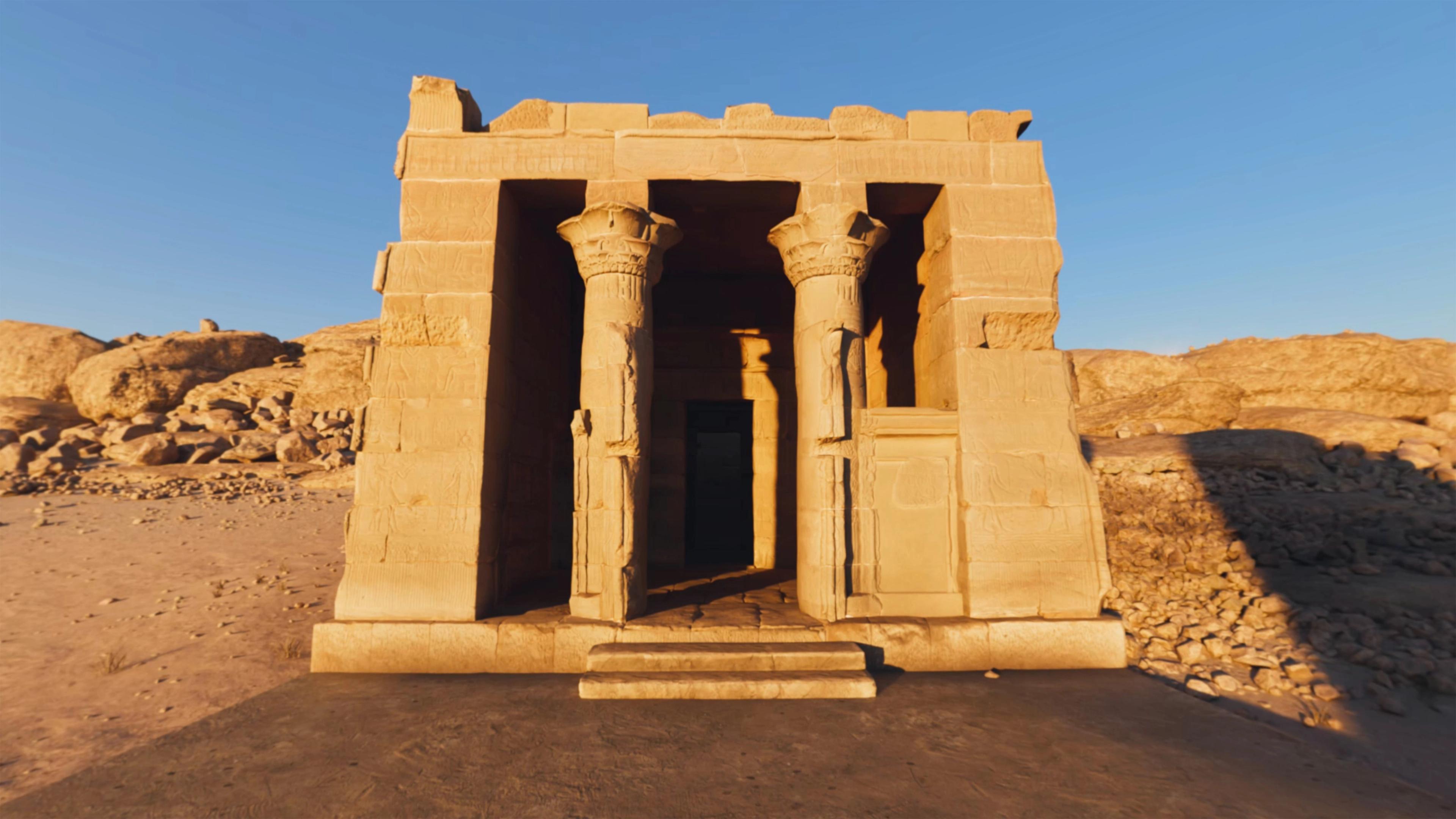 Stone temple with decorated columns in a rocky desert landscape.