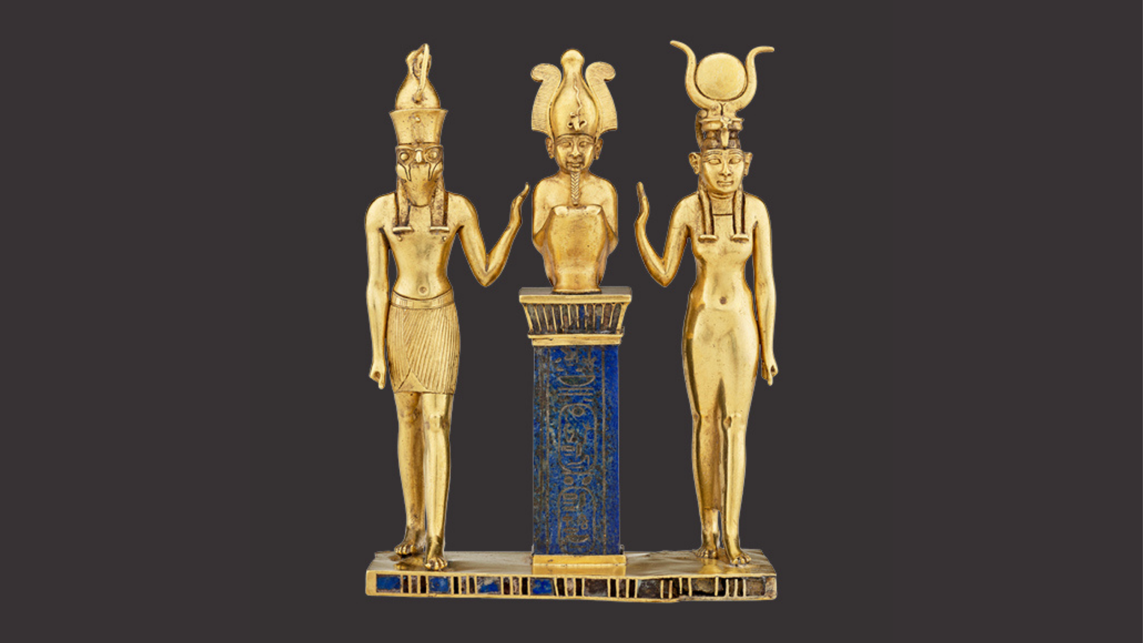 Triad of Osiris, Horus, and Isis. From Egypt, probably Thebes, Karnak Temple. Third Intermediate Period, Dynasty 22, reign of Osorkon II (about 872–837 BCE). Gold inlaid with lapis lazuli. Acquired in 1872. Paris, Louvre Museum, Department of Egyptian Antiquities (E 6204). © 2025 GrandPalaisRmn (Louvre Museum). Photo: Mathieu Rabea