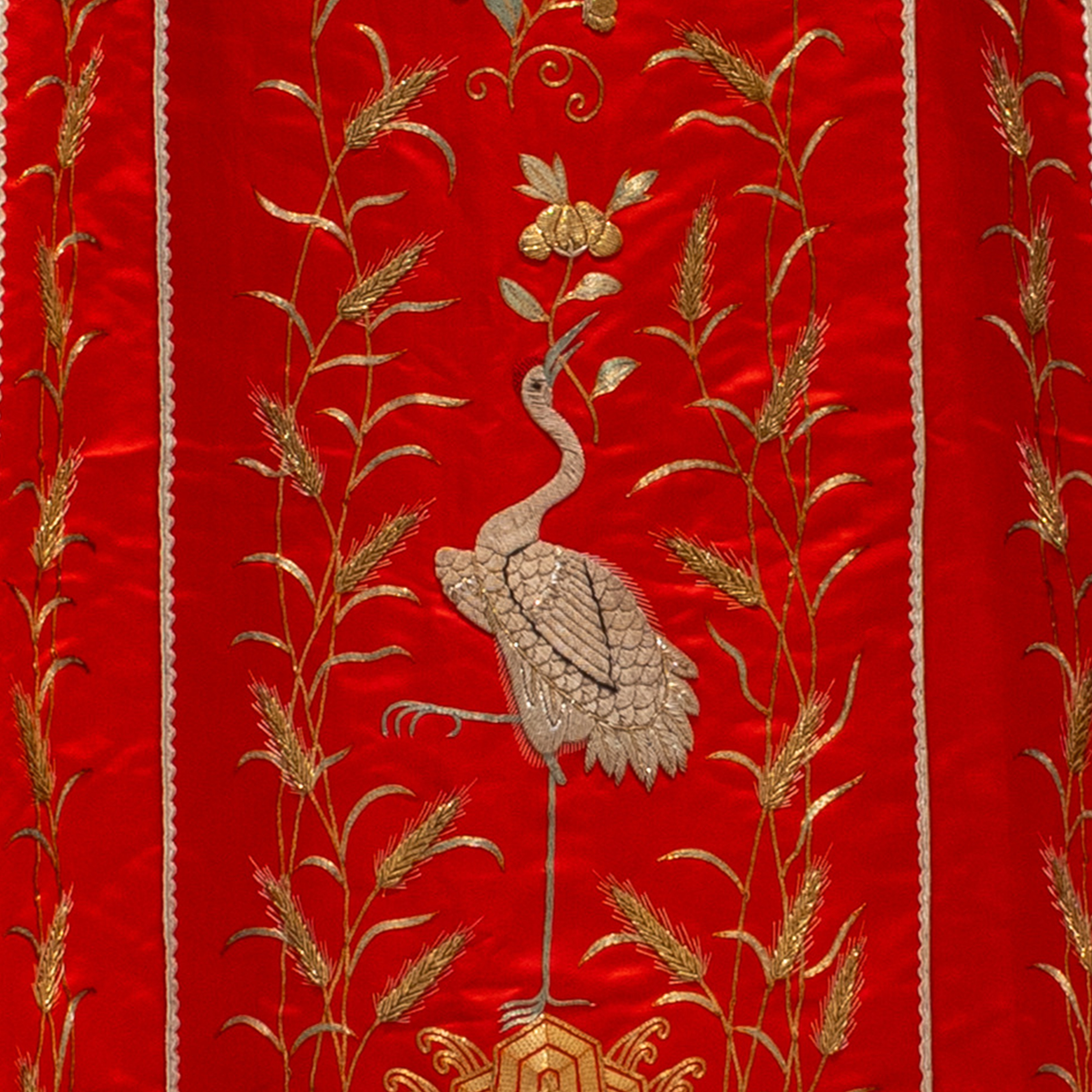 A traditional black robe features intricate gold embroidery with circular dragon motifs. 