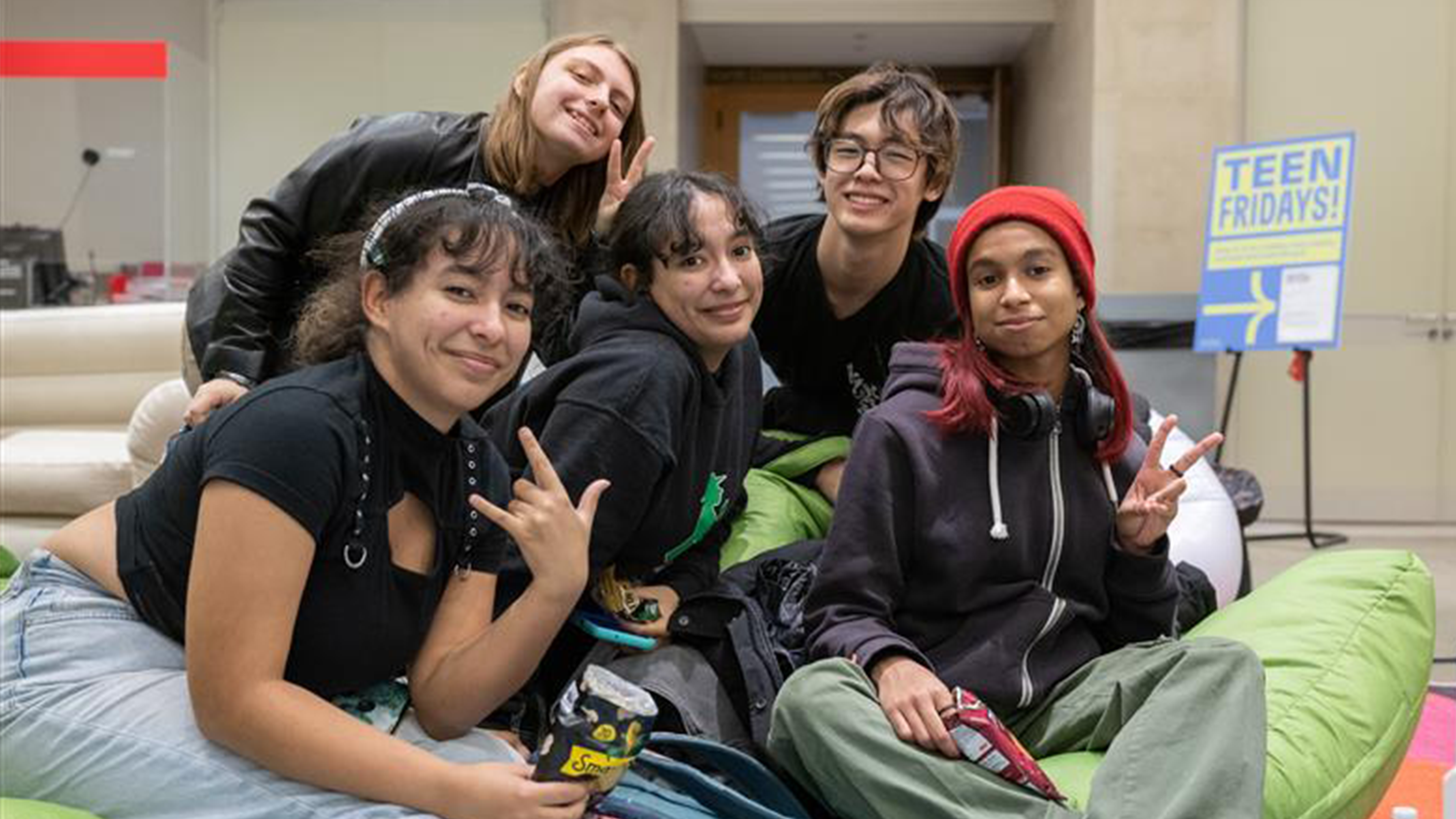Three teens walking down a hallway in The Met's Ruth and Harold D. Uris Center for Education